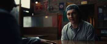 Movie still from “Dumb Money” (2023), directed by Craig Gillespie – A woman sitting at a table in front of a man; Close Up shot, Over the shoulder angle