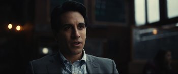 Movie still from “Dumb Money” (2023), directed by Craig Gillespie – A person wearing a suit and tie; Close Up shot, Over the shoulder angle