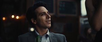 Movie still from “Dumb Money” (2023), directed by Craig Gillespie – A person wearing a suit and tie; Close Up shot, Low angle