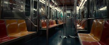 Movie still from “Dumb Money” (2023), directed by Craig Gillespie – A subway train car with seats on the floor; Extreme Wide shot, High angle