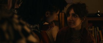 Movie still from “Dumb Money” (2023), directed by Craig Gillespie – Two women are talking in a dimly - lit room; Close Up shot, Over the shoulder angle