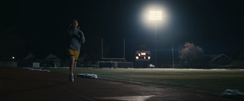 Movie still from “Dumb Money” (2023), directed by Craig Gillespie – A man is running on a field at night; Wide shot, Low angle