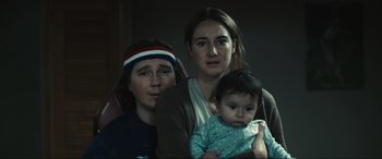 Movie still from “Dumb Money” (2023), directed by Craig Gillespie – Two women and a baby are posing for a picture; Close Up shot, Low angle