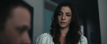 Movie still from “Dumb Money” (2023), directed by Craig Gillespie – A person with long brown hair; Close Up shot, Over the shoulder angle