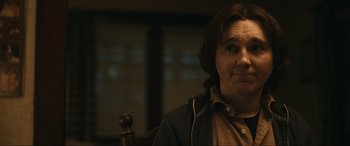 Movie still from “Dumb Money” (2023), directed by Craig Gillespie – A man with a beard is sitting in a chair; Close Up shot, Over the shoulder angle