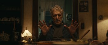 Movie still from “Dumb Money” (2023), directed by Craig Gillespie – An older man sitting in front of a mirror; Close Up shot, Over the shoulder angle