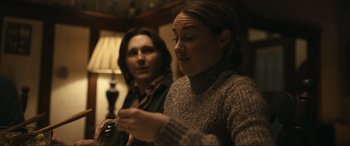 Movie still from “Dumb Money” (2023), directed by Craig Gillespie – Two women sitting in front of each other in a room; Close Up shot, Over the shoulder angle