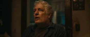 Movie still from “Dumb Money” (2023), directed by Craig Gillespie – An older man is looking into the distance; Close Up shot, Low angle