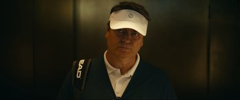 Movie still from “Dumb Money” (2023), directed by Craig Gillespie – A person wearing a visor; Close Up shot, Low angle