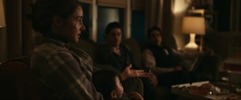 Movie still from “Dumb Money” (2023), directed by Craig Gillespie – A group of people sitting in a room; Medium shot, Over the shoulder angle