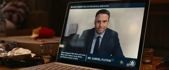 Movie still from “Dumb Money” (2023), directed by Craig Gillespie – A laptop with a picture of a man; Medium shot, High angle