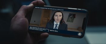 Movie still from “Dumb Money” (2023), directed by Craig Gillespie – A person is holding a cell phone in their hand; Extreme Close Up shot, High angle