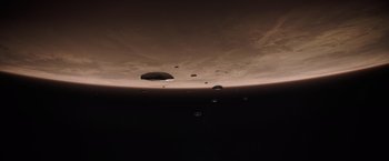 Movie still from “Dune” (2021), directed by Denis Villeneuve – A group of ufos flying in the sky above the earth; Extreme Wide shot, Overhead angle