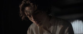 Movie still from “Dune” (2021), directed by Denis Villeneuve – A man with curly brown hair wearing a white shirt; Close Up shot, Low angle