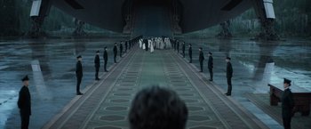 Movie still from “Dune” (2021), directed by Denis Villeneuve – A group of people standing in front of an airplane; Extreme Wide shot, Over the shoulder angle