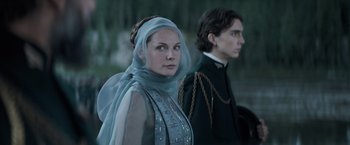 Movie still from “Dune” (2021), directed by Denis Villeneuve – A man and a woman standing next to each other; Medium shot, Low angle