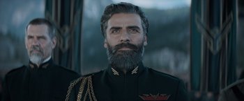 Movie still from “Dune” (2021), directed by Denis Villeneuve – A man with a long beard and a military uniform on; Close Up shot, Low angle