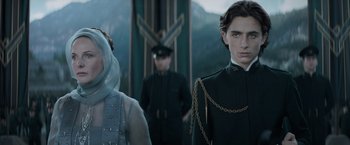 Movie still from “Dune” (2021), directed by Denis Villeneuve – A man and a woman standing next to each other in front of mountains; Close Up shot, Low angle