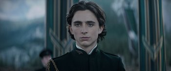 Movie still from “Dune” (2021), directed by Denis Villeneuve – A man with long dark hair wearing a uniform; Close Up shot, Low angle
