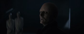 Movie still from “Dune” (2021), directed by Denis Villeneuve – A man with bald head in a dark room; Close Up shot, High angle