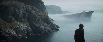 Movie still from “Dune” (2021), directed by Denis Villeneuve – A body of water near a cliff with a mountain in the background; Extreme Wide shot, High angle