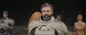 Movie still from “Dune” (2021), directed by Denis Villeneuve – A man with a beard wearing a suit of armor; Close Up shot, Low angle