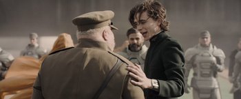 Movie still from “Dune” (2021), directed by Denis Villeneuve – A young man talking to an older man in a military uniform; Medium shot, Over the shoulder angle