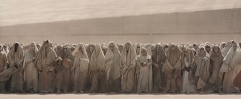 Movie still from “Dune” (2021), directed by Denis Villeneuve – A large group of people standing in a line; Wide shot, High angle