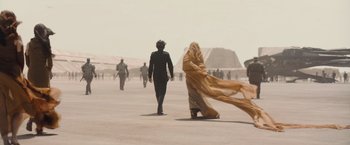 Movie still from “Dune” (2021), directed by Denis Villeneuve – A man and a woman walking on a beach; Wide shot, Over the shoulder angle