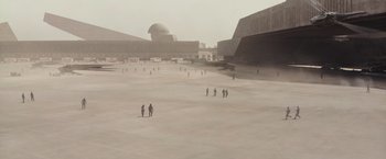 Movie still from “Dune” (2021), directed by Denis Villeneuve – A group of people standing on top of a sandy beach; Extreme Wide shot, High angle