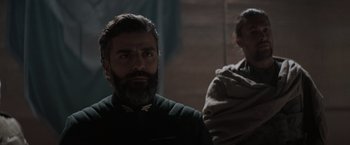 Movie still from “Dune” (2021), directed by Denis Villeneuve – A man with a long beard is looking at the camera; Close Up shot, Over the shoulder angle