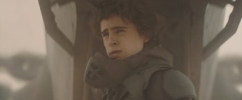 Movie still from “Dune” (2021), directed by Denis Villeneuve – A young man with a messy hair style; Close Up shot, Low angle