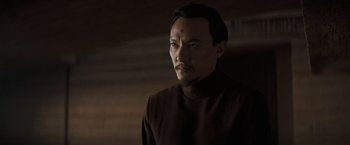 Movie still from “Dune” (2021), directed by Denis Villeneuve – A man in a brown shirt looking to his left; Close Up shot, Over the shoulder angle