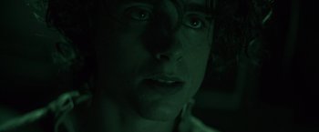 Movie still from “Dune” (2021), directed by Denis Villeneuve – A man's face in the dark; Close Up shot, Low angle