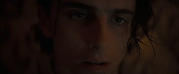 Movie still from “Dune” (2021), directed by Denis Villeneuve – A person's face with tears coming out of their eyes; Extreme Close Up shot, Low angle