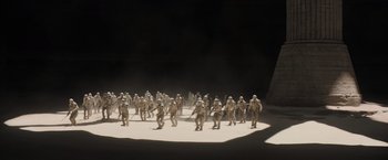 Movie still from “Dune” (2021), directed by Denis Villeneuve – A group of people standing on top of a dirt field; Extreme Wide shot, High angle