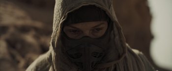 Movie still from “Dune” (2021), directed by Denis Villeneuve – A person wearing a mask and a hood; Close Up shot, Low angle