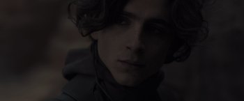 Movie still from “Dune” (2021), directed by Denis Villeneuve – A person wearing a black shirt; Close Up shot, Low angle
