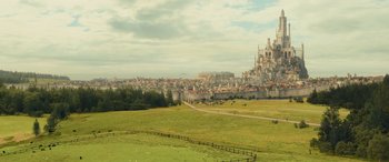 Movie still from “Dungeons & Dragons: Honor Among Thieves” (2023), directed by John Francis Daley – An aerial view of a town with a castle in the background; Extreme Wide shot, High angle