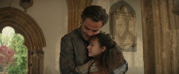 Movie still from “Dungeons & Dragons: Honor Among Thieves” (2023), directed by John Francis Daley – A man and a woman embracing each other; Medium shot, Low angle