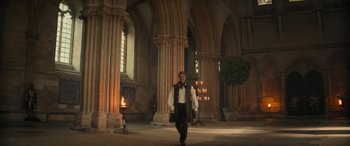 Movie still from “Dungeons & Dragons: Honor Among Thieves” (2023), directed by John Francis Daley – A man walking in a large room with pillars; Wide shot, Low angle