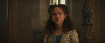 Movie still from “Dungeons & Dragons: Honor Among Thieves” (2023), directed by John Francis Daley – A young woman with curly hair and a necklace; Close Up shot, Over the shoulder angle