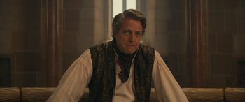 Movie still from “Dungeons & Dragons: Honor Among Thieves” (2023), directed by John Francis Daley – A person sitting in a chair wearing a vest; Close Up shot, Over the shoulder angle