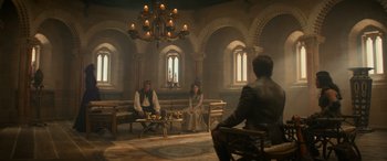 Movie still from “Dungeons & Dragons: Honor Among Thieves” (2023), directed by John Francis Daley – Two people sitting in a room with candles; Wide shot, High angle