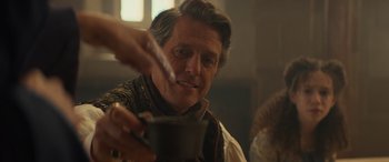 Movie still from “Dungeons & Dragons: Honor Among Thieves” (2023), directed by John Francis Daley – A man holding a bowl of food while looking at the camera; Close Up shot, Over the shoulder angle