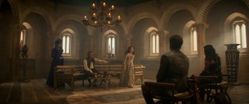 Movie still from “Dungeons & Dragons: Honor Among Thieves” (2023), directed by John Francis Daley – A man and a woman are standing in a room; Wide shot, High angle