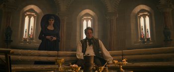 Movie still from “Dungeons & Dragons: Honor Among Thieves” (2023), directed by John Francis Daley – A man and a woman sitting at a dining table; Wide shot, Over the shoulder angle