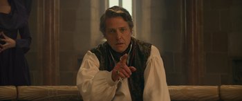 Movie still from “Dungeons & Dragons: Honor Among Thieves” (2023), directed by John Francis Daley – A man in a medieval outfit is pointing to the camera; Close Up shot, Over the shoulder angle