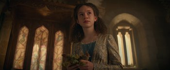 Movie still from “Dungeons & Dragons: Honor Among Thieves” (2023), directed by John Francis Daley – A young woman holding a bunch of plants; Medium shot, Low angle