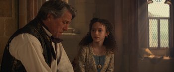 Movie still from “Dungeons & Dragons: Honor Among Thieves” (2023), directed by John Francis Daley – A man and a young girl are standing next to each other; Medium shot, Over the shoulder angle